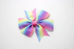 Detailed close-up of rainbow gradient grosgrain ribbon layers on a girls hair clip bow