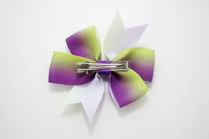 Detailed back view of a rainbow gradient bow hair clip with silver metal alligator grip