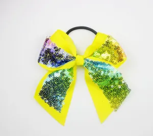 Yellow ribbed bow hair tie with colorful gradient sequins and a thick black elastic band