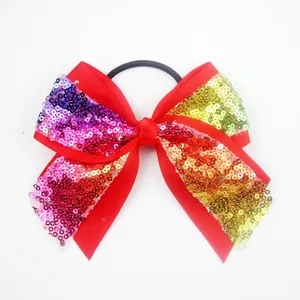 Red grosgrain ribbon bow hair tie with vibrant rainbow sequin wings for girls