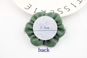 Detailed back view of a 7.5cm forest green fabric flower with a white felt attachment pad