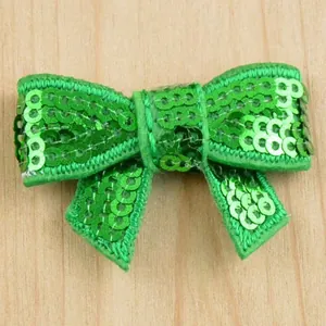 Detailed view of handmade sparkling bright green sequin bow for DIY hair accessories