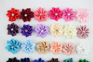 Detailed view of handmade multi-color polyester ribbon flowers with center diamond accents