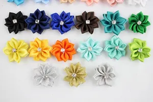 Close-up of colorful handmade polyester ribbon flowers with central rhinestone centers