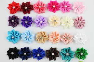 Macro view of 24 colors DIY polyester ribbon flowers with central rhinestone centers