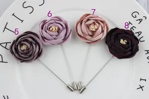 Detailed view of handmade fabric rose lapel pins in various elegant colors with long needles