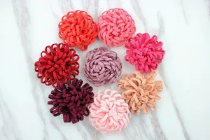 Detailed flat lay of colorful 3.5cm DIY handmade fabric flower accessories in 8 warm tones