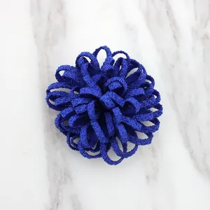 Detail of 3.5cm royal blue handmade fabric flower with granular texture for DIY crafts