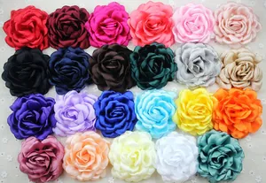 Detail of multi-color chiffon peony flower pins in a large variety of vibrant fabric colors