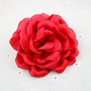 Detailed macro view of large red chiffon peony flower with layered fabric petals