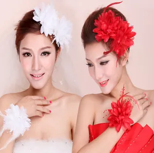 Detailed set of feather and lace flower hair clips with wrist corsages for dance performances