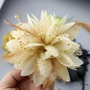 Detail of champagne feather floral hair clip with beads for dance performances