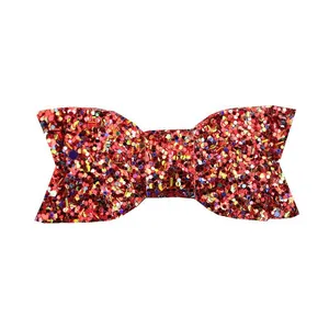 Close-up of a vibrant red sequin bow hair clip with colorful shimmering details