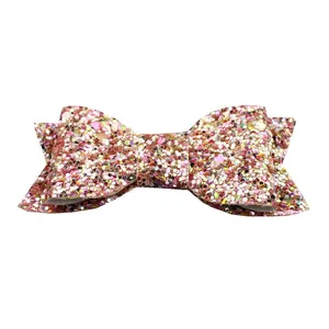 Macro detail of handmade glitter bow with pink and gold sequins for hair accessories