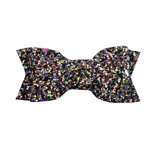 Macro detail of multi-color glitter sequins on a black handmade bow hair accessory