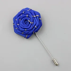 Detail of handmade blue fabric rose lapel pin with long silver needle for men's suits