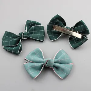Detail of checkered fabric double bow hair clips for girls with metal alligator clips
