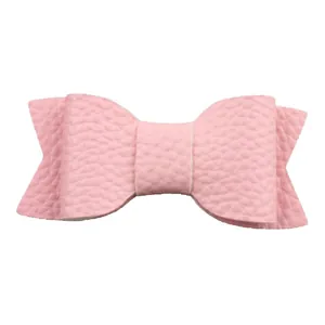 Detailed view of pink faux leather hair bow clip with soft pebble grain texture for girls
