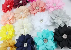 Flat lay of colorful chiffon flowers with sparkling rhinestone centers for DIY crafts