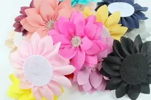 Flat lay of colorful chiffon fabric flowers with rhinestone centers and felt back pads