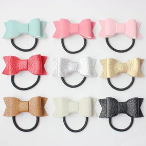 Set of 9 colorful faux leather bow hair ties with lychee texture on white background