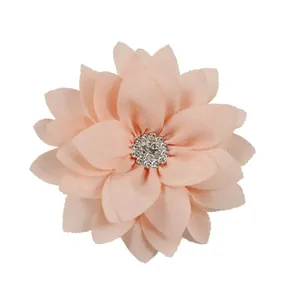Detail of a 9cm dusty pink layered fabric flower with a sparkling rhinestone center