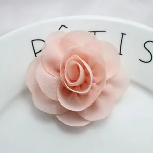 Detailed view of layered peach chiffon fabric rose flower for DIY hair accessories