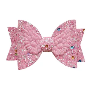 Pink glitter bow hair accessory with angel wings and colorful crystal rhinestones
