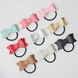 9-piece set of faux leather bow hair ties with lychee texture in assorted vibrant colors