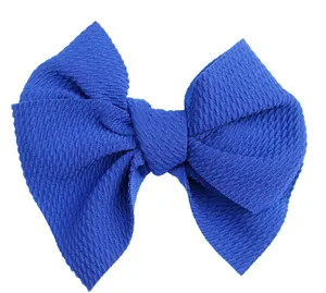 Detail of 5-inch royal blue textured fabric bow for DIY hair accessories and apparel