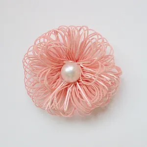 Handmade pink flower brooch with a glossy white pearl center in a minimalist retro style