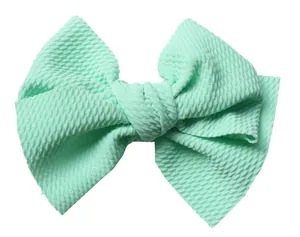 Close-up of 5 inch mint green bullet fabric bow with textured grain for DIY hair accessories