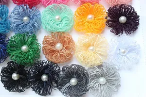 Detailed view of colorful handmade fabric flower petals with central pearl accents