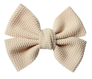 Detail of cream waffle texture fabric bow with a layered design for DIY hair accessories