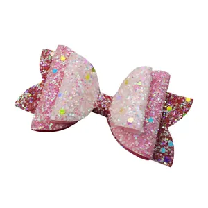 Close-up of pink sequined bow accessory with colorful star and round glitter details