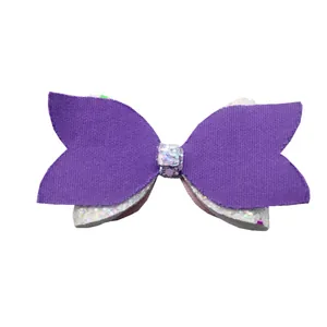 Close-up of double-layered purple and glittery white bow for DIY hair accessories