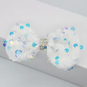 Détail de nœud en velours blanc avec paillettes colorées et strass bleus pour bricolage