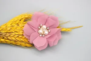 Macro shot of 6cm pink chiffon fabric flower with pearl centers and rhinestone detail