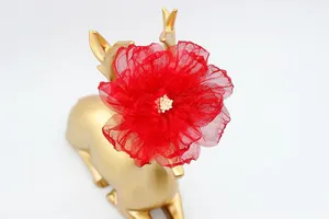 Vista dettagliata di un fiore di organza rossa di 9cm fatto a mano con stami bianchi