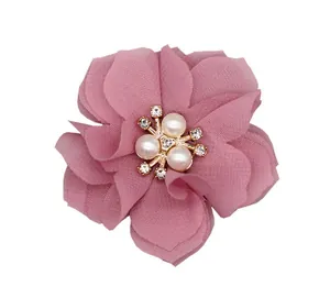 Detail of pink chiffon flower with central pearls and rhinestones for hair accessories