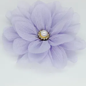 Detailed view of handmade lavender chiffon flower with pearl and crystal center embellishment