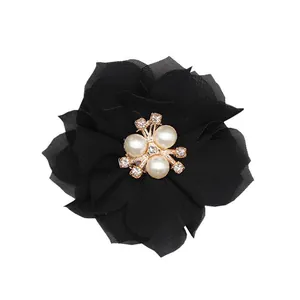 Detail of a 6cm black chiffon flower with gold alloy rhinestones and pearl center