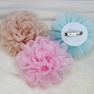Three 9cm multilayer organza flower brooches in champagne, pink, and light blue colors