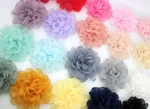Close-up of 9cm layered organza peony flowers showing diverse colors and textures