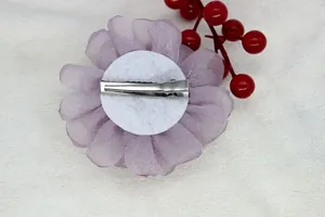 Back view of handmade purple organza peony hair clip with silver metal duckbill clamp