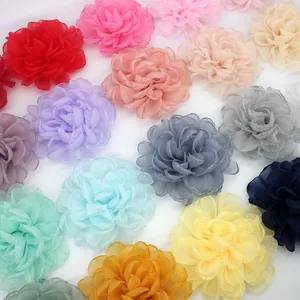 Flat lay of colorful handmade organza peony flowers for DIY bridal hair accessories