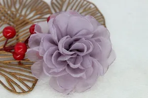 Detail of lavender organza fabric flower with silver glitter edges for DIY crafts