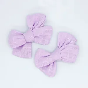 Macro shot of two lavender cotton-linen bows with detailed fabric texture for DIY crafts