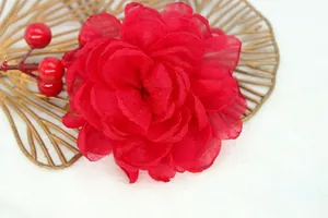 Detailed macro view of a 9cm red organza flower brooch with layered fabric petals