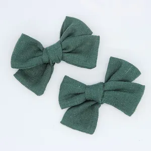 Detailed texture of dark green cotton linen bow accessories for DIY baby hair clips
